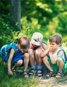 curiosity - children being curious about a bug