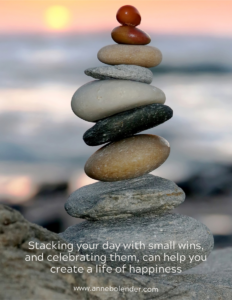 stacking your day with small wins - a stack of pebbles at a beach