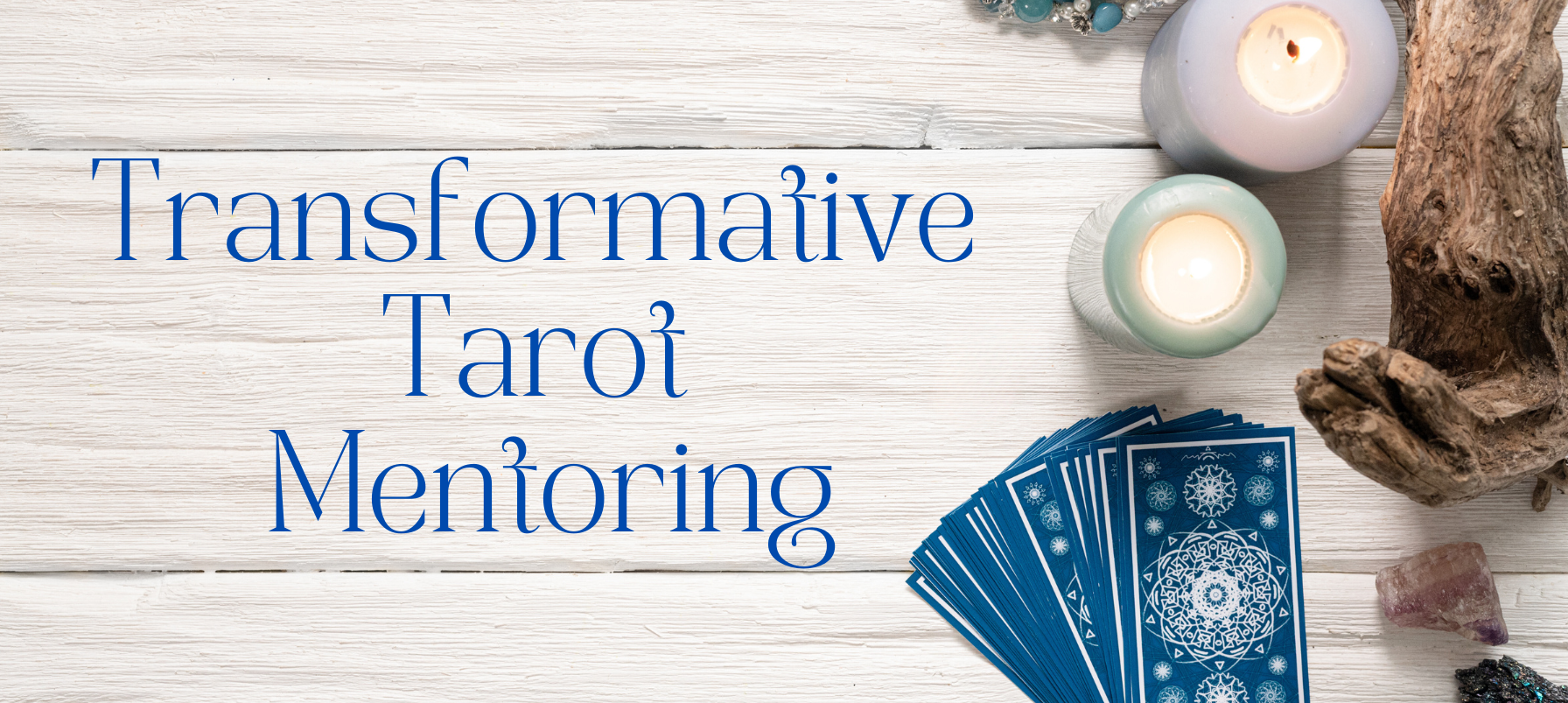 a deck of blue tarot cards and come candles sit on a whitewashed wooden table, with the words "Transformative Tarot Mentoring" on it