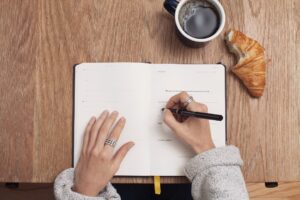 women writing in her journal