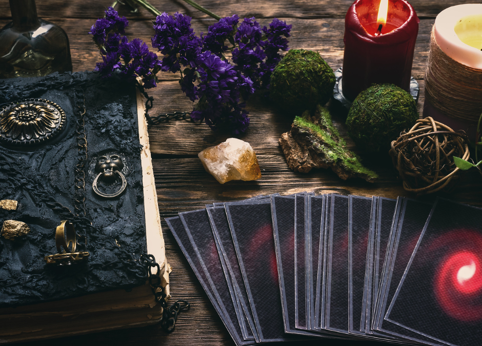 tarot cards, red candle, leather bound journal, set out for tarot journaling