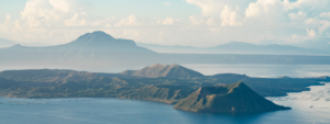 image in cool blue tomes of a bay surrounded by mountains